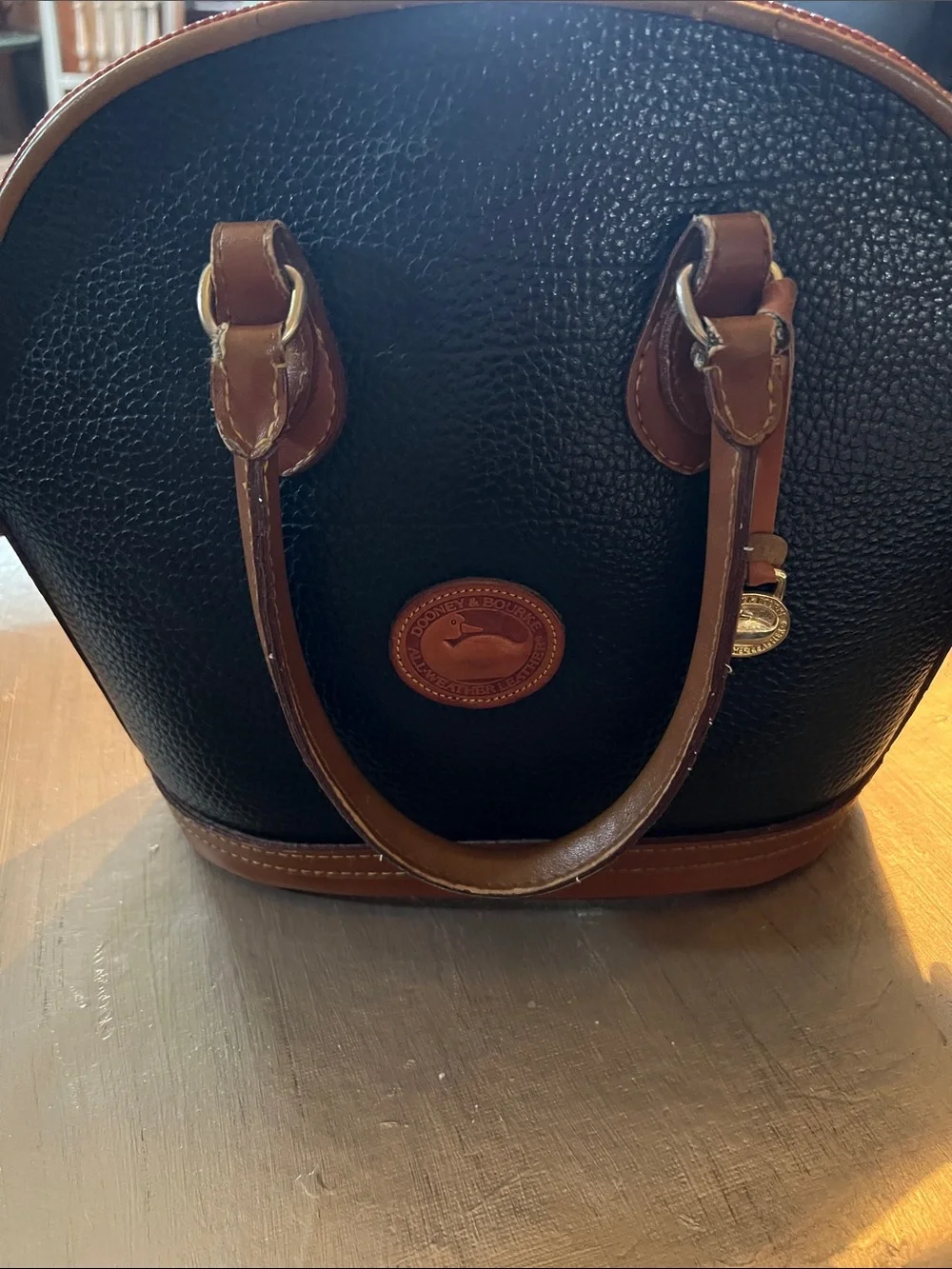 Dooney & Bourke Black Pebbled Leather Satchel with Brown Trim and Handles
